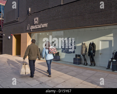 Chinesische Touristen besuchen Luxus Aquascutum neue Outlet Fabrikverkauf in Hackney, London, neben Burberry Outlet. Stockfoto