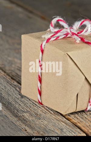 Packpapier-Paket mit Streichern, Weihnachtsgeschenk in Recycling-Papier eingewickelt gefesselt Stockfoto