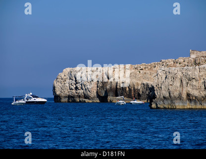 Italien, Sizilien, Portopalo di Capo Passero (Provinz Siracusa), Boote und die felsige Küste der Insel Capo Passero Stockfoto