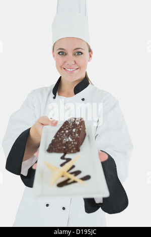 Junge Köchin mit Gebäck Stockfoto