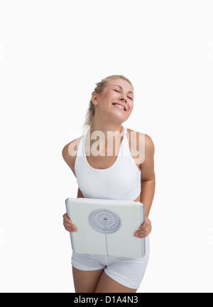 Begeistert junge glücklich Frau mit Waage Stockfoto