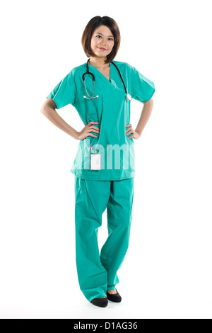 Chinesische Frau Doktor tragen, die eine grüne Scrubs und Stethoskop. Isoliert auf weiss. Voller Länge Portrait. Stockfoto