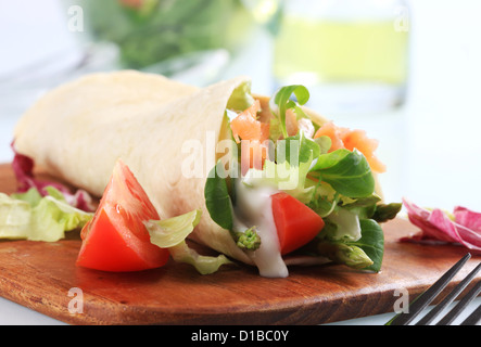 Tortilla gefüllt mit frischem Gemüse und geräuchertem Lachs Stockfoto