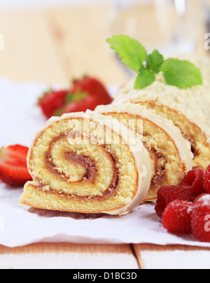 Biskuitrolle mit weißer Schokolade Zuckerguss glasiert Stockfoto