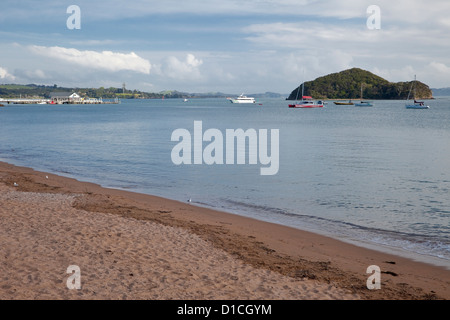 Paihia Bay, Fähre von Russell Arriving, Waitangi Treaty Grounds in Ferne. Paihia, Nordinsel, Neuseeland. Stockfoto