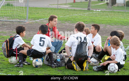 Trainer diskutieren Fußball-Spiel-Strategie mit jungen 10 Jahren während einer Ruhepause. Monroe Memorial Park St. Paul Minnesota MN USA Stockfoto