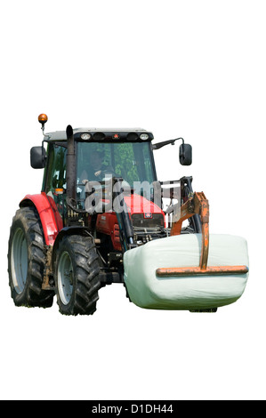 Massey Ferguson 5460 Traktor mit einem Strohballen Stockfoto