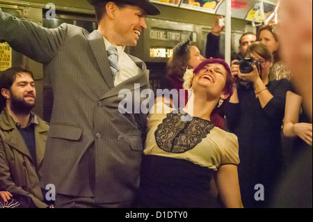 New Yorker, Touristen und u-Bahn Stärkungszauber, einige im historischen Gewand, Reisen auf einem Vintage MTA Nostalgie Zug Weihnachten Saison Fahrt Stockfoto