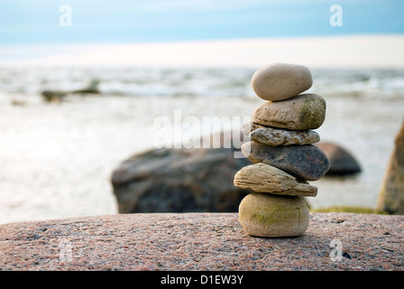 Stapel von Steinen am Ufer des Meeres im Abendlicht, Nahaufnahme Stockfoto