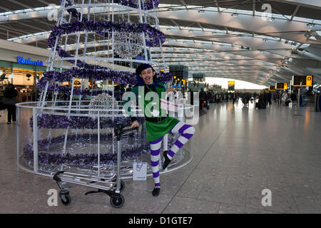 21. Dezember 2012.  T5 Flughafen Heathrow, London. Ein Schauspieler verkleidet in einem Elf-Kostüm, Reisende, was erwartet wurde, zu den verkehrsreichsten Tag für Weihnachten Reisen zu unterhalten. © Danny Callcut Stockfoto