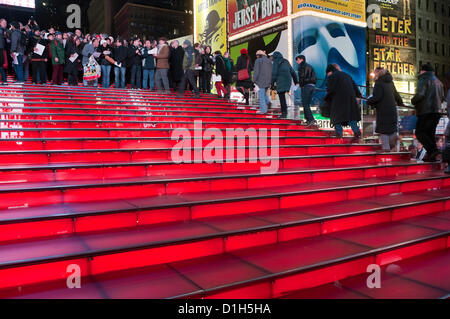 New York, NY - 21 Dezember 2012 über 500 Menschen erfüllt die rote Schritte auf dem Times Square willkommen Yoko Ono, Witwe des verstorbenen John Lennon, um Frieden von Lied Lennons "Imagine" mehrere hundert mehr versammelten sich in der Mall der Duffy Square zum Mitsingen zu feiern.  Zeitgleich mit der Wintersonnenwende zusammen, war das Lied Führung durch Thomas McCarger, Dirigent und Sänger, und unter der Schirmherrschaft von Make Music New York. Stockfoto