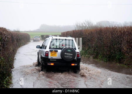 22. Dezember 2012. Autofahrer, die ihren Weg durch die überfluteten Vennaway Gasse in der Nähe von Swansea heute Nachmittag als Teile der Halbinsel Gower wurden überschwemmt mit dem Starkregen fegt in ganz Großbritannien. Stockfoto