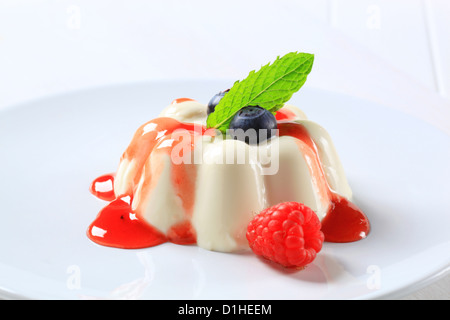 Pannacotta mit Fruchtcoulis und Waldbeeren Stockfoto