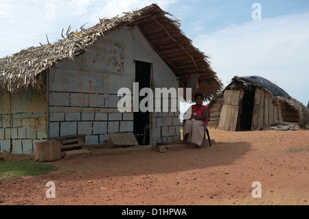 Frau sitzt vor ihrem Haus, streichelte ihr Haustieren Katze, im Dorf von Waikkal, Sri Lanka Stockfoto