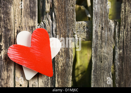 Rote und weiße Herzen auf verwitterten Holzplanken mit Textfreiraum Stockfoto