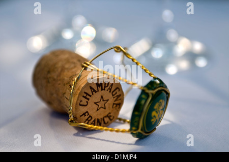 Sektkorken auf weiße Tischdecke mit Draht binden Rahmen und Deckel Gläser hinter Stockfoto