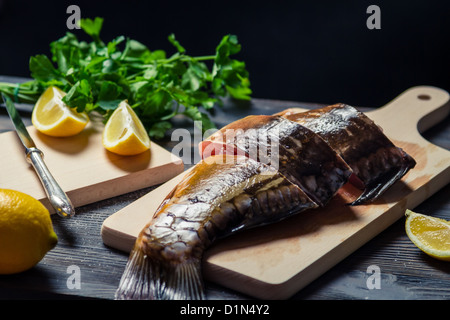 Frischer Fisch auf dem Brett vor dem Braten in Scheiben geschnitten Stockfoto