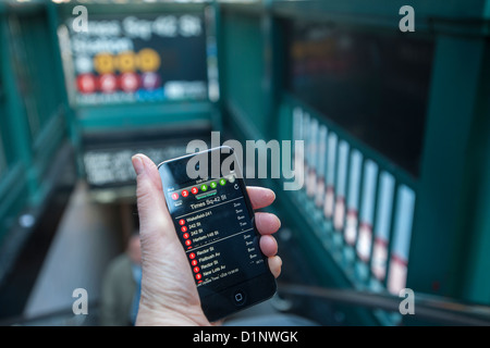 Ein u-Bahn-Fahrer überprüft die neue app der MTA U-Bahn Zeit außerhalb der Times Square Station in New York Stockfoto