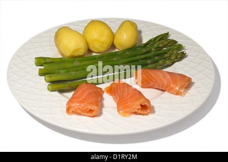 eine Platte mit Spargel, Lachs und Kartoffeln isoliert auf weißem Hintergrund Stockfoto