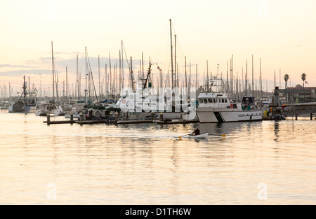 Ruderboot und Yachten im Hafen von Ventura in der Morgendämmerung als Sonne steigt Stockfoto