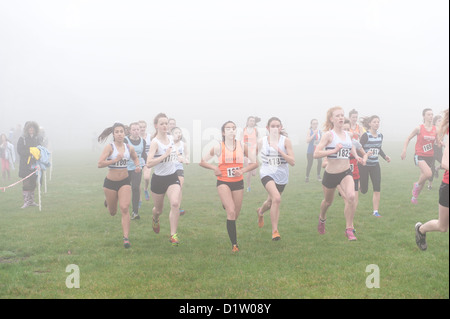 Kent Cross Country Meisterschaften unter 15 Mädchen Jugend läuft auf Trail-Pfad durch Wald im Nebel und nebligen Bedingungen ausgeführt Stockfoto