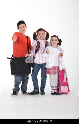 Drei Schüler mit Taschen Stockfoto