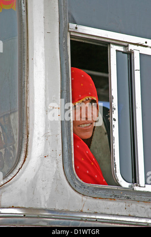 Porträt einer Rajasthani Frau Blick durch ein Fenster in einem Bus auf dem Weg nach Pushkar in Rajasthan, Indien. Stockfoto