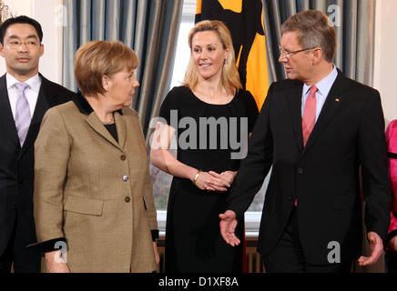 German President Christian Wulff (R) und seine Frau Bettina (2-R) begrüßen die deutsche Bundeskanzlerin Angela Merkel, während deutsche Bundesminister für Wirtschaft und Technologie, Philipp Rösler (L) neben ihnen während der Neujahrsempfang im Schloss Bellevue in Berlin, Deutschland, 12. Januar 2011 steht. Der Regierungschef erhält traditionell Bürger und Vertreter aus dem Bereich der Kultur, Wirtschaft und Politik an den Neujahrsempfang. Foto: WOLFGANG KUMM Stockfoto