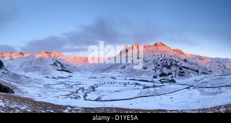 Rosa Dawn Sonnenlicht auf den Langdale Pikes und Nordwestgrat im Winter im englischen Lake District Stockfoto