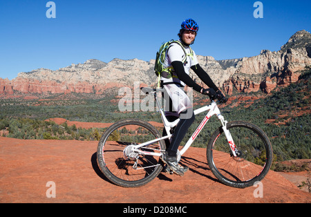 Mountainbiker in Sedona, Arizona, mit u-Boot Rock in Ferne Stockfoto