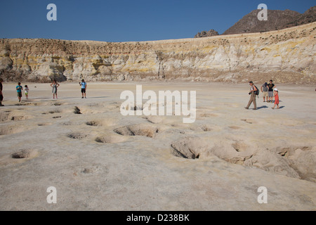 Touristen, die auf dem Kraterboden des hydrothermalen Vulkankraters Stefanos auf der Agäischen Insel Nisyros spazieren Stockfoto