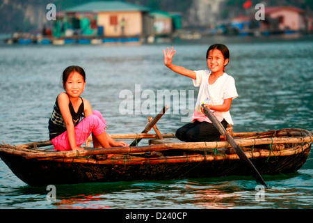 Mädchen in eine traditionelle Rudern Boot in der Halong-Bucht, Golf von Tonkin, Vietnam, Asien. Stockfoto