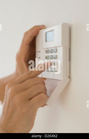 USA, New Jersey, Jersey City, Hand Einstellcode auf Alarmanlage Stockfoto