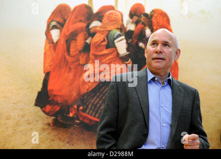 US-amerikanischer Fotograf Steve McCurry posiert vor seinem Foto "Sandsturm" (Rajasthan, Indien, 1983) während einer Pressekonferenz im Kunstmuseum in Wolfsburg, Deutschland, 17. Januar 2013. Die Exhibiiton zeigt einige 100 Fotografien aus asiatischen Ländern, die von 1980 bis 2011 entstanden. Foto: HOLGER HOLLEMANN Stockfoto