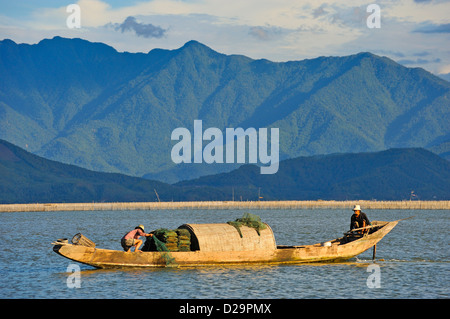 Vietnamesische Landschaft mit Fischern und Jungen mit Fischfalle auf dem Lagunensee in Phu Loc, Provinz Thua Thien-Hue Stockfoto