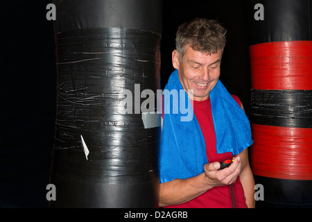 Mann Lesung Stoppuhr im Fitness-Studio Stockfoto