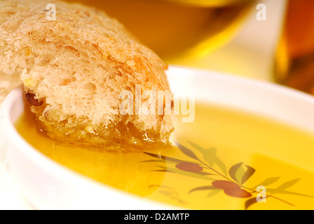 Frisch gebackenen Stück knuspriges Brot in eine Schüssel mit Olivenöl Stockfoto