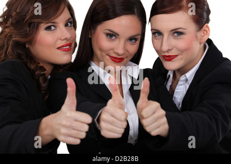 Drei Geschäftsfrauen die Daumen aufgeben. Stockfoto
