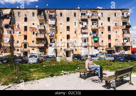 Albanischen Mann sitzt auf einer Bank in einem heruntergekommenen Park von Tirana, Albanien Stockfoto