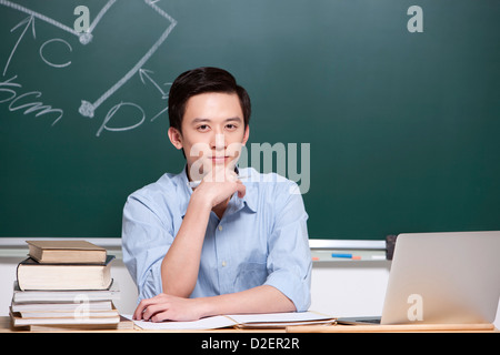 Schweren männlichen Lehrer Hand am Kinn im Klassenzimmer Stockfoto