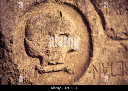 Grabstein mit ominösen Gravur von einem alten Schädel Stockfoto