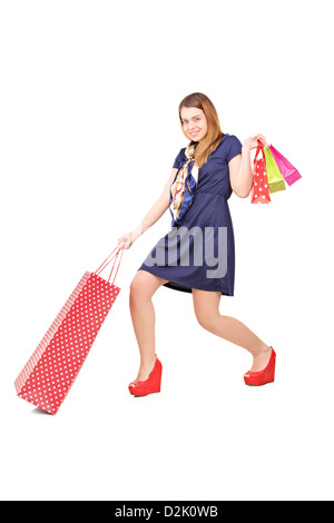 In voller Länge Portrait von einer schönen jungen Frau Einkaufstaschen isoliert auf weißem Hintergrund Stockfoto