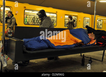 Ein Obdachloser ruht auf einer Bank in einer u-Bahnstation in Berlin, Deutschland, 24. Januar 2013. Aufgrund der eisigen Kälte Obdachlose Havbe Zuflucht in Lobby-Bereichen der Banken und Bahnhöfe. Foto: Paul Zinken Stockfoto