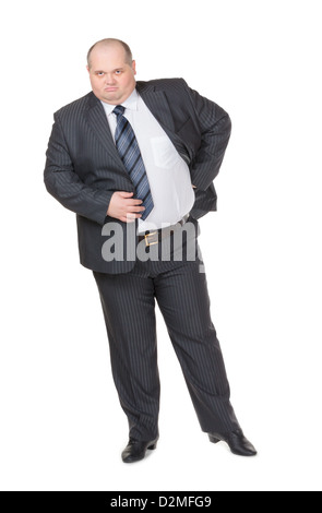 Fett Übergewicht Geschäftsmann in einem stylischen Anzug steht mit seiner Hand auf seine Hüfte finster in die Kamera Stockfoto