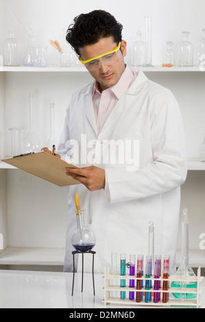 Wissenschaftler schreiben auf einem Klemmbrett in einem Labor Stockfoto