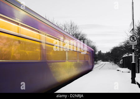 Erster Zug von Middlesbrough nach Whitby auf der malerischen Esk Valley Linie verlassen Schnee bedeckten Kildale Bahnhof bei Sonnenaufgang. Stockfoto