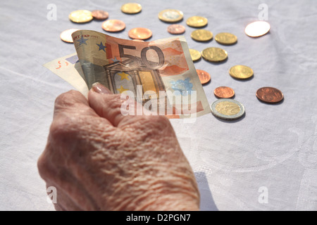 Berlin, Deutschland, die Hand eines Rentners mit ein-Euro-Schein und Münzen Stockfoto