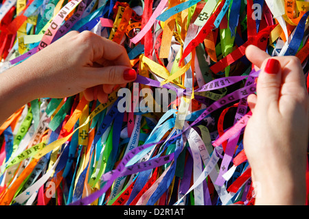 Frau binden Glück Band am Igreja Nosso Senhor Bonfim Kirche, Salvador (Salvador de Bahia), Bahia, Brasilien, Südamerika Stockfoto