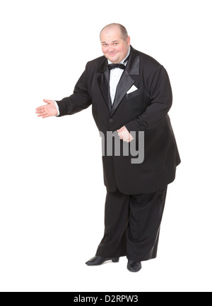 Elegante dicker Mann in einen Smoking und Fliege lächelt charmant wie er seine Hand auf die Seite gestikulieren hält Stockfoto