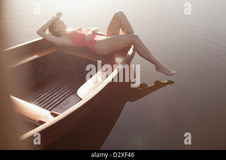 Ruhige Frau, Sonnenbaden in Boot auf See Stockfoto